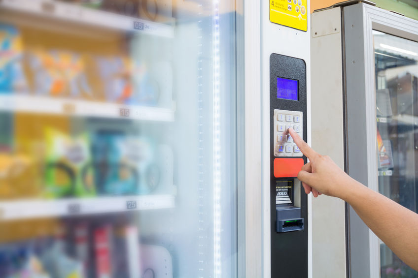 Person buying snack at vending machine